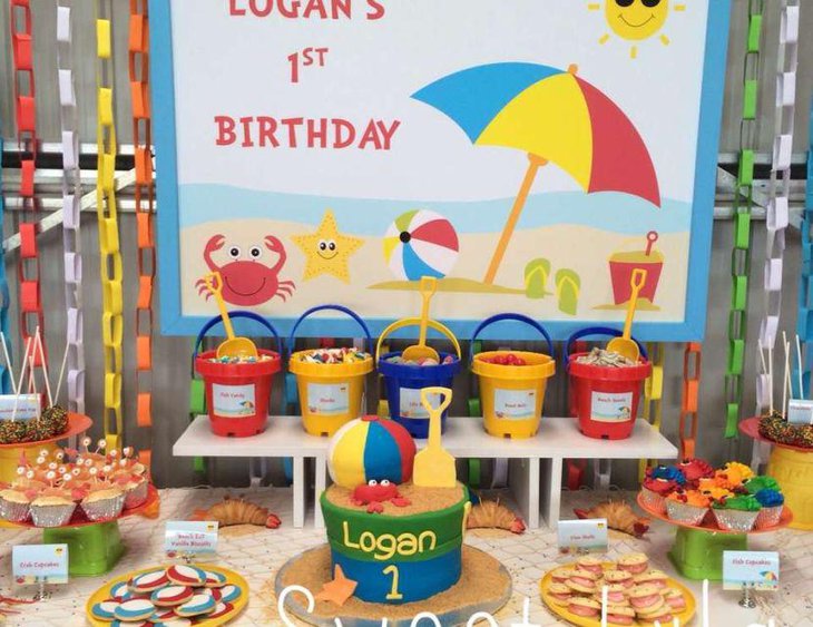 A beach themed summer birthday party table for 1st birthday