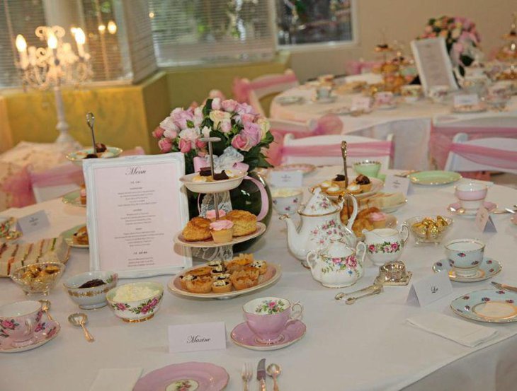 Appealing birthday table decor with pink accented flowers and cups
