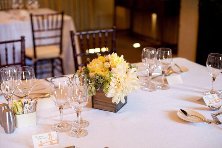 Stunning white and yellow floral centerpiece on birthday table